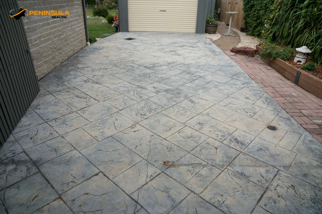 Faded stamped concrete driveway before professional driveway painting on the Mornington Peninsula