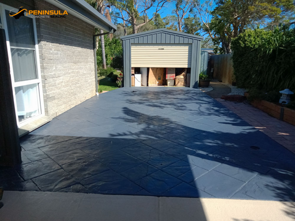 Stamped concrete driveway after driveway painting in bluestone finish